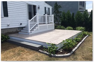 DECK CONSTRUCTION - ...We completed the new deck with a wide staircase applied a white Azek skirting.