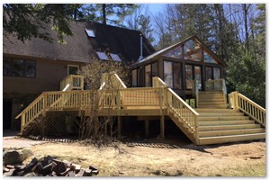 NEW DECK - We removed and disposed of an old deck in Exeter. We built a new pressure treated deck with multiple and wide staircases. We finished off the railings with angle balusters with a wide top cap.