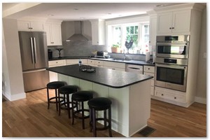 Shaker style cabinets with granite counter tops a sit down island. New Hampshire remodel.