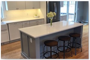 Shaker style cabinets with Corian counter tops and a sit down island. New Hampshire renovation.