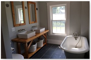 Master bathroom renovation with custom vanity, tiled shower and a stand alone cast iron tub located in Stratham.