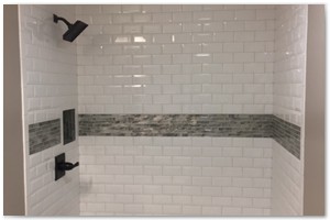 FAMILY BATHROOM RENOVATION - We tore out and renovated a family bathroom in Exeter. We installed a deep soaking tub with white beveled subway tile and smoke glass accent tile.
